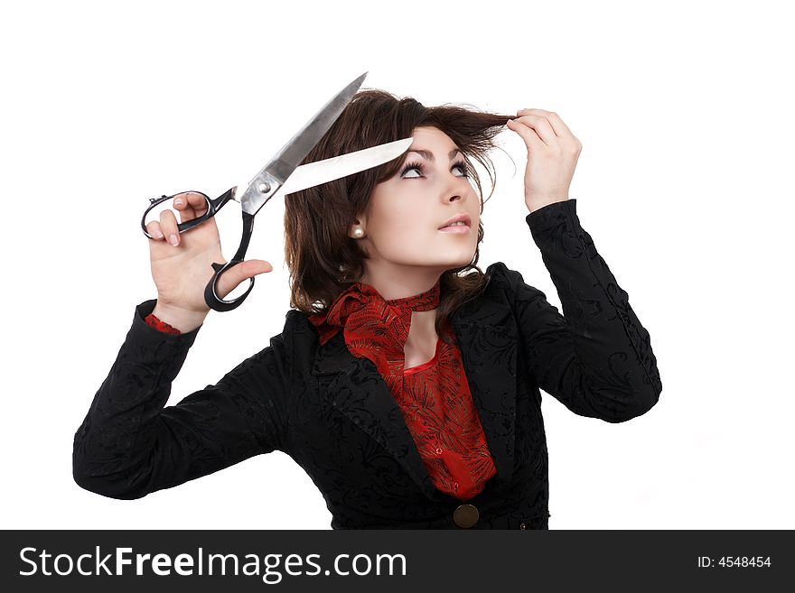 A woman with big scissors going to cut her forelock