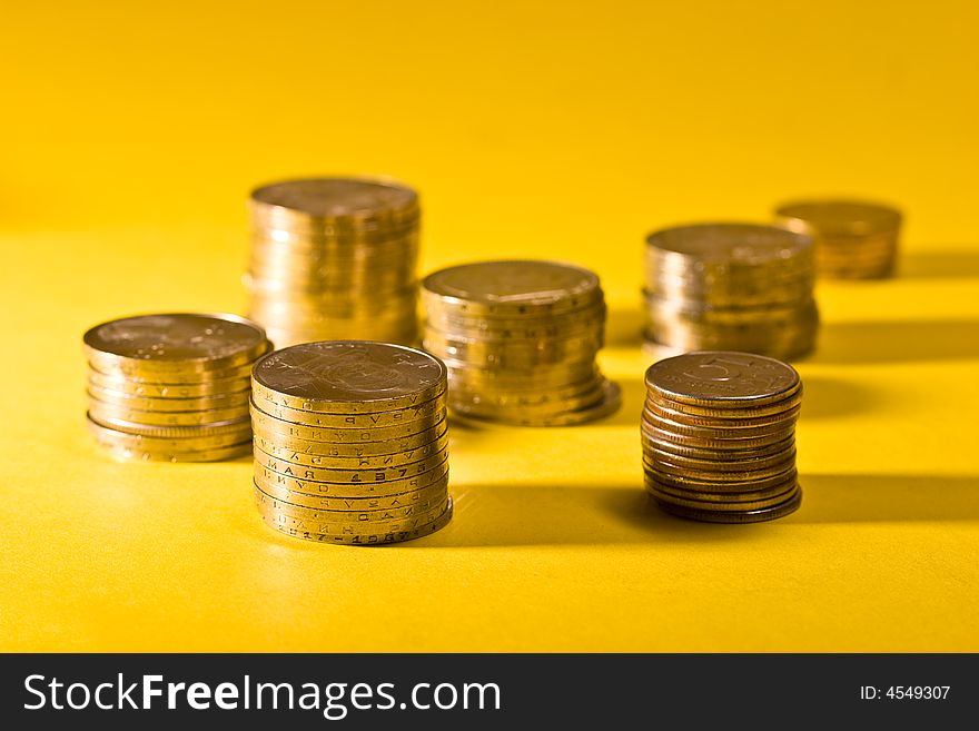 Money series: coins on the yellow background