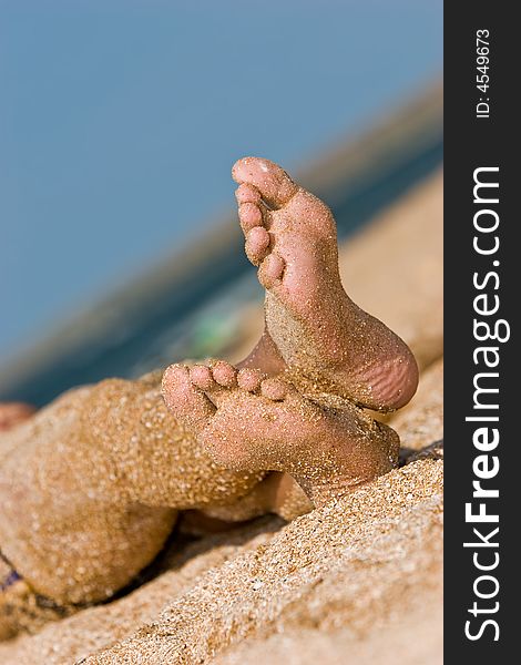 Leisure seies: sandy foot on summer sea beach