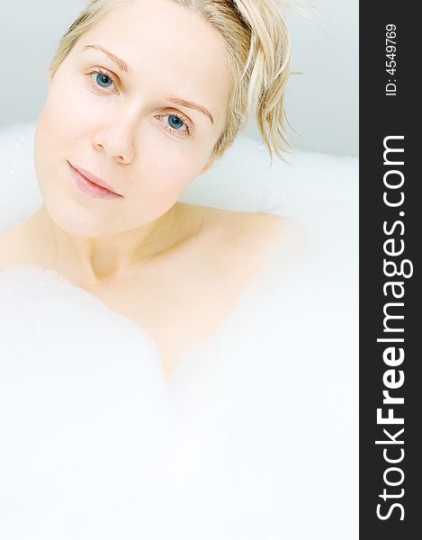 Woman in bathtub with blue eyes