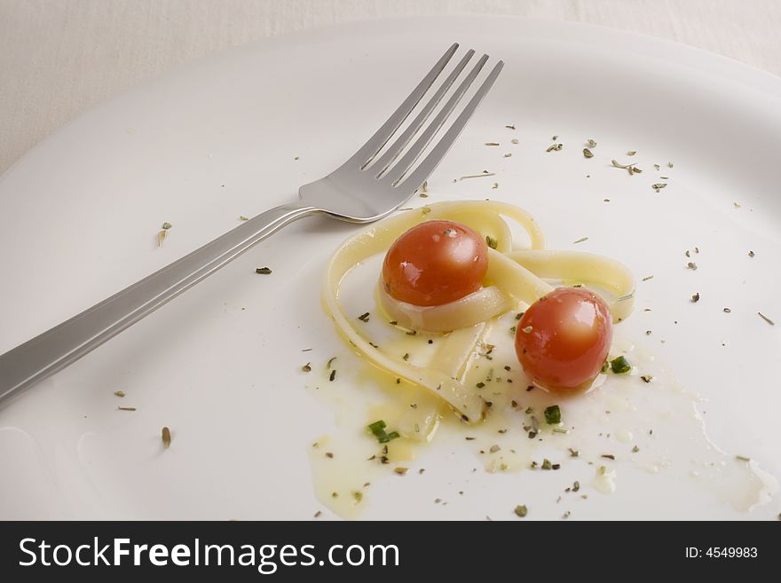 Plate with fetuccini and tomato. Plate with fetuccini and tomato