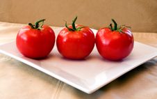 3 Red Vine Ripened Tomatoes On A White Plate. Royalty Free Stock Photo 3 Red Vine Ripened Tomatoes On A White Plate. Royalty Free Stock Photo