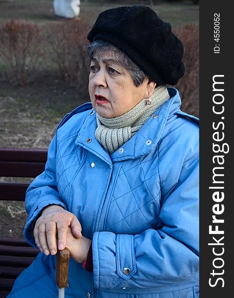 Elderly woman confide story of her life sitting on bench