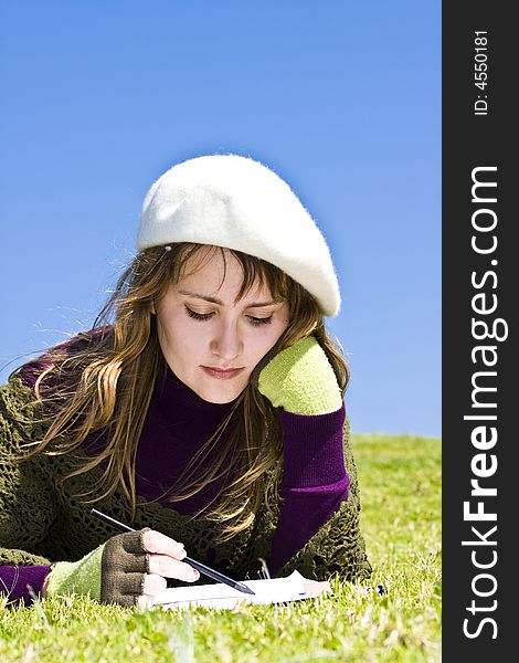 Woman painting on the grass.