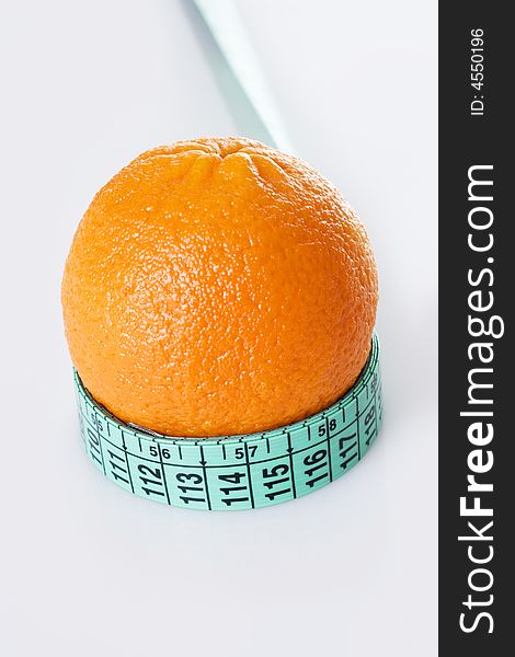Fresh orange and measuring tape
