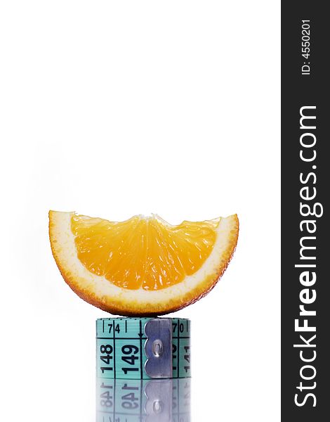 Fresh piece of orange on measuring tape. Fresh piece of orange on measuring tape