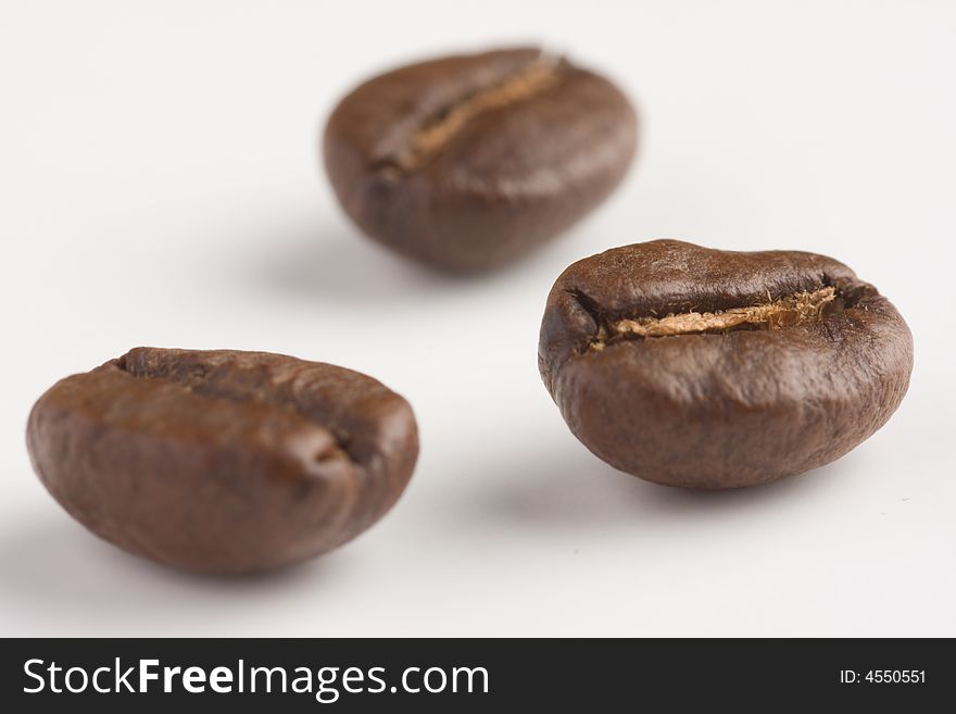 Three coffeebeans in a macro shot.