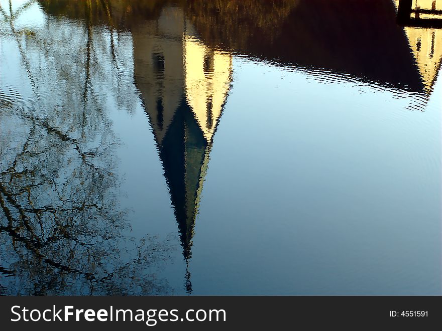 Reflection of Blaubeuren's conventual church in the Blautopf spring pond. Blaubeuren is located near Ulm, South-Germany. Reflection of Blaubeuren's conventual church in the Blautopf spring pond. Blaubeuren is located near Ulm, South-Germany.