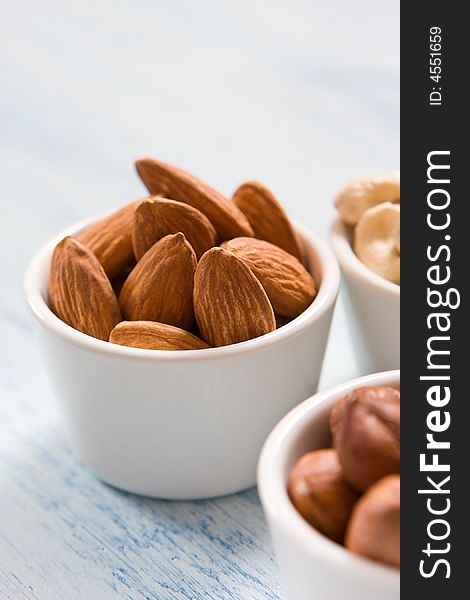 Hazelnut, almonds and acajou in the white dishes. Hazelnut, almonds and acajou in the white dishes