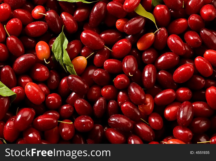 Cornelian cherries, background of nature with liaves