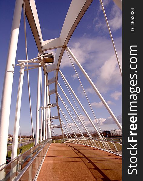 A pedestrian bridge over a highway at a bus station