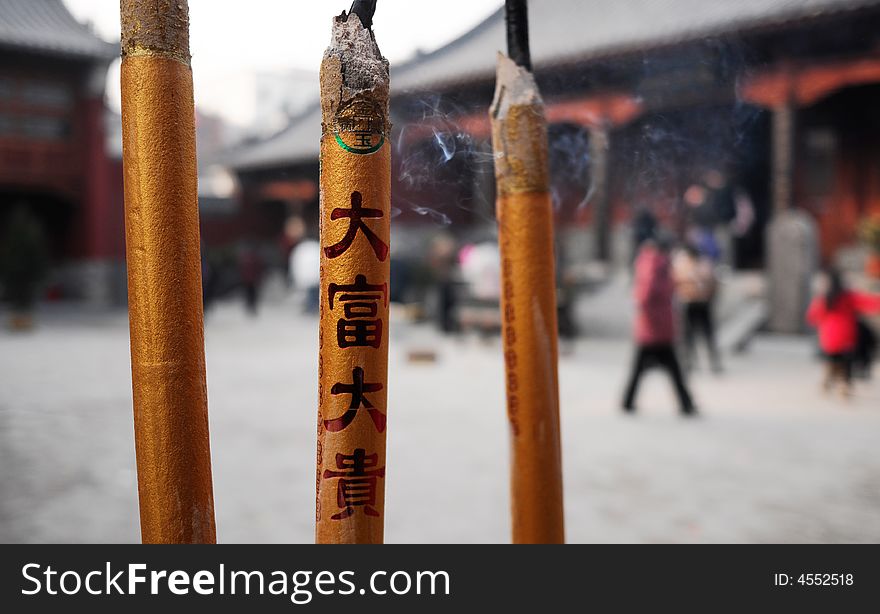 In Chinese,people often go to temple to burn incense to pray for good luck,health,fortune,etc.
the letters on incense means rich,fortune