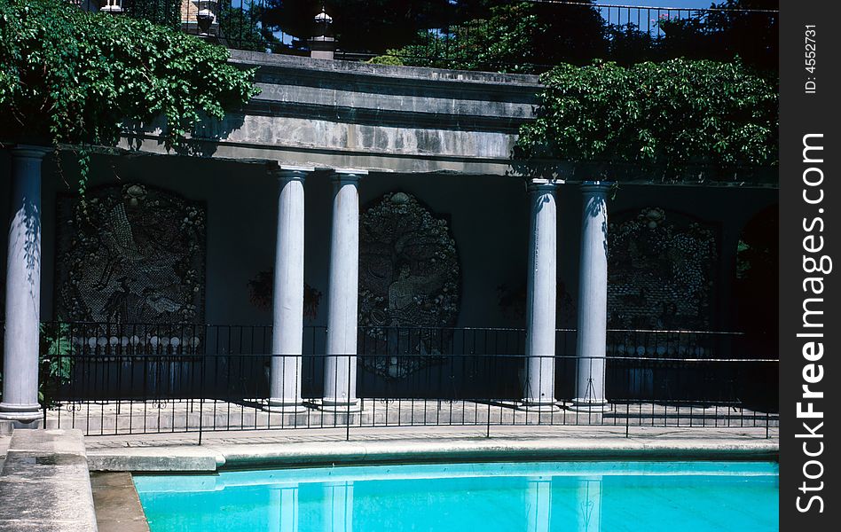 Pillars and art surround a pool. Pillars and art surround a pool