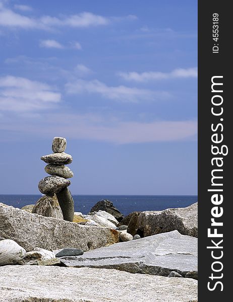 A statue constructed of rocks in the shape of a man. A statue constructed of rocks in the shape of a man