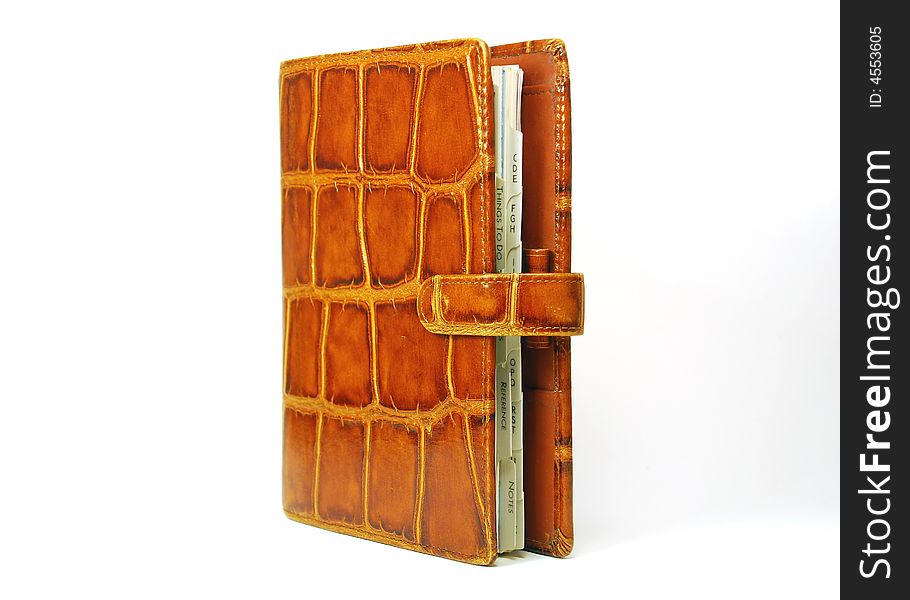 Leather organizer, standing up, bright orange textured leather, old-fashioned PDA. Leather organizer, standing up, bright orange textured leather, old-fashioned PDA