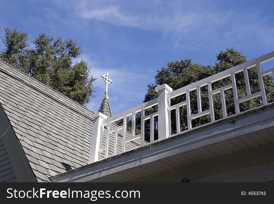 An old church roof with steeple and widows walk