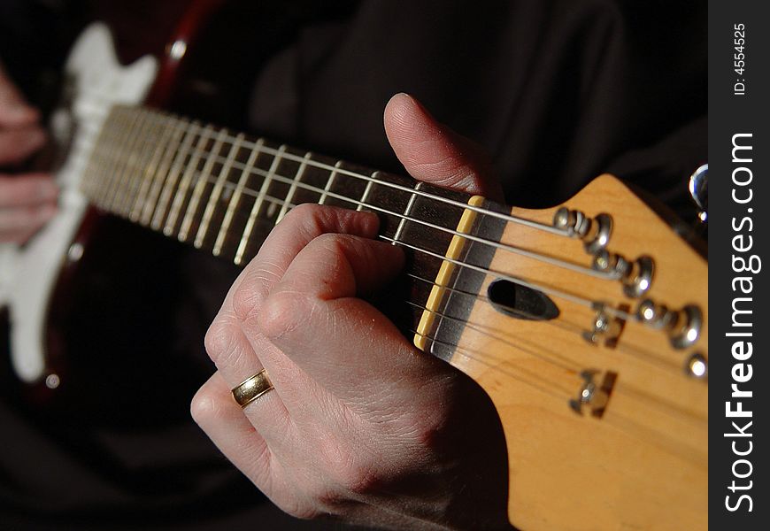 A man playing an electric guitar. A man playing an electric guitar