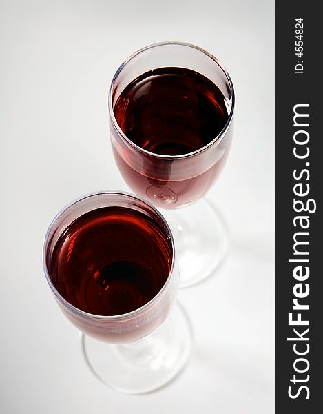 Two beautiful fashionable glasses with red wine