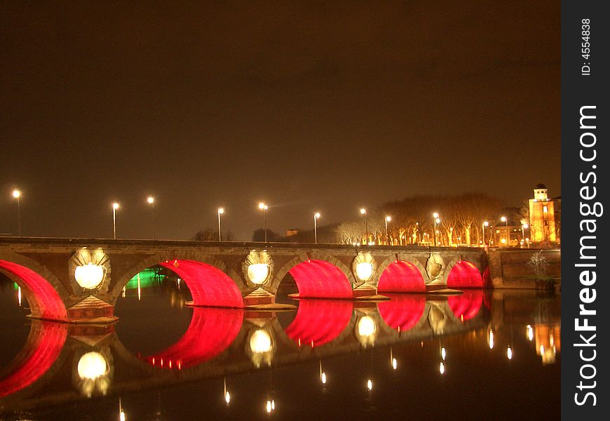 A colorful bridge at night in the toulouse