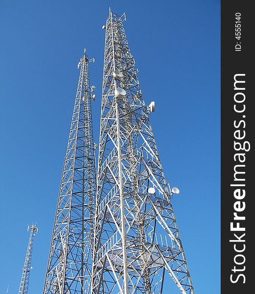 Long telecommunication antennas under blue sky