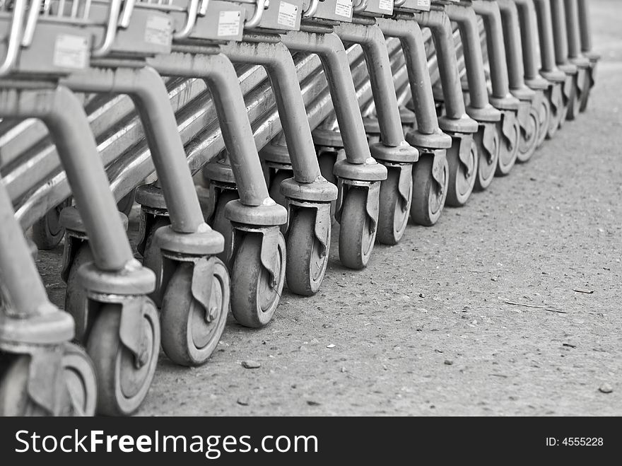 Photograph of the wheels of a group of shopping carts. Photograph of the wheels of a group of shopping carts