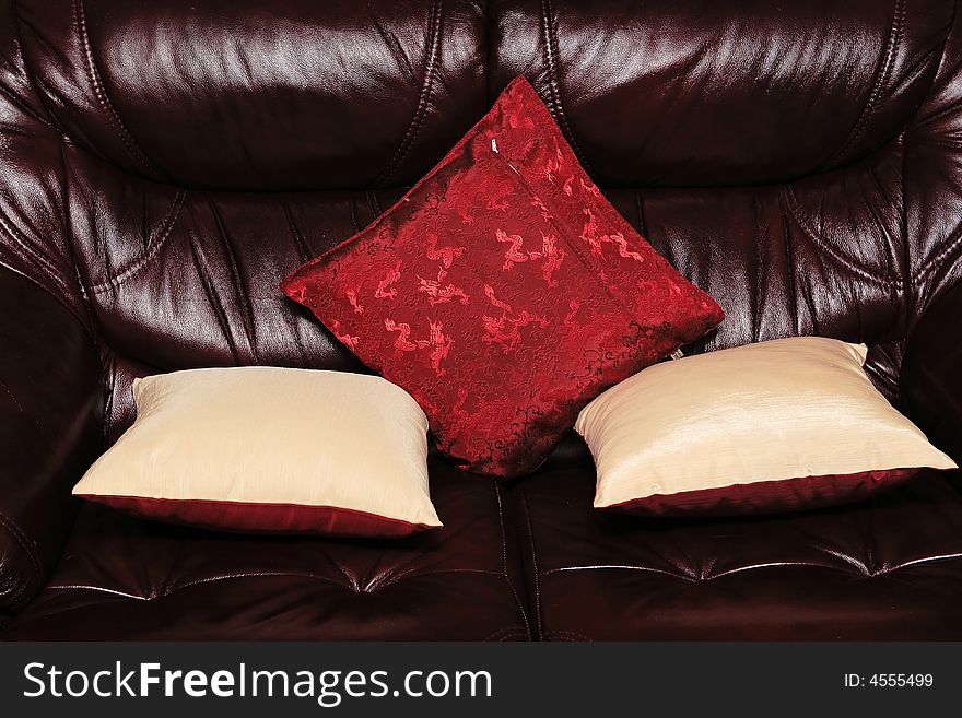 Leather sofa with three pillows