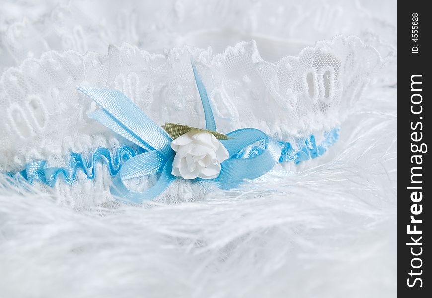 Wedding details. garter with flower and blue laces