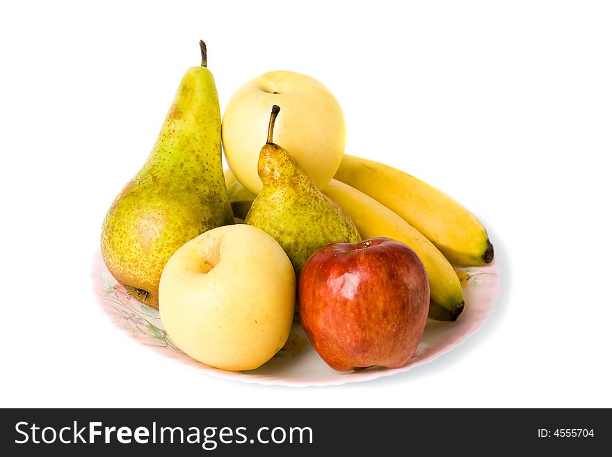 Different fruits laying on the plate isolated with white background. Different fruits laying on the plate isolated with white background