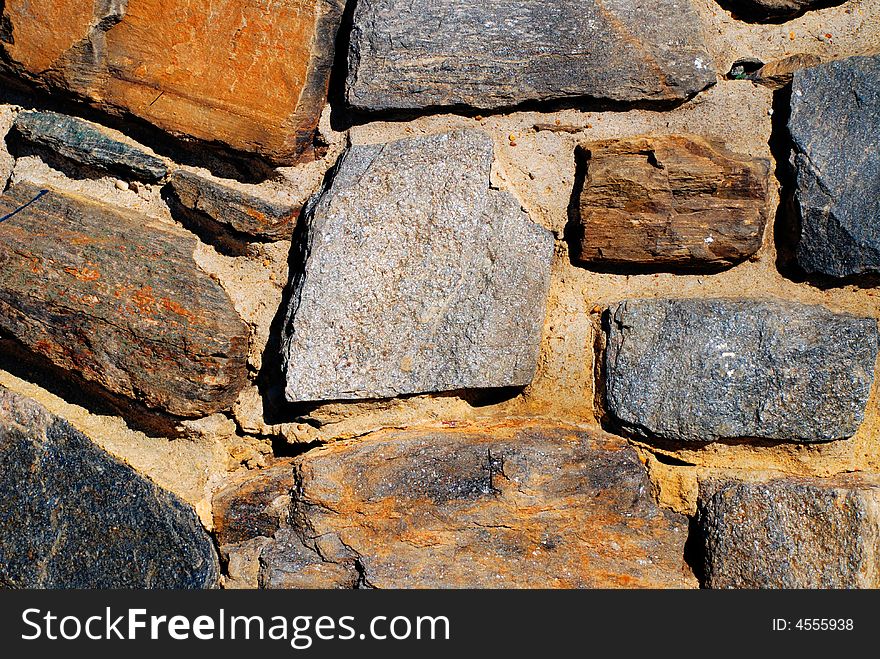 Orange, brown and blue stone wall