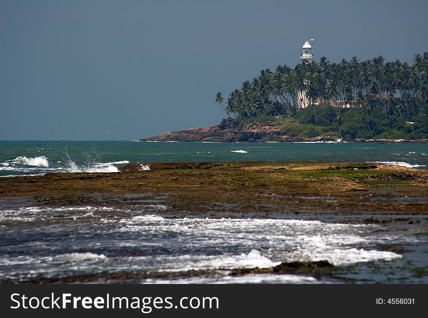 Island with lighthouse and palms