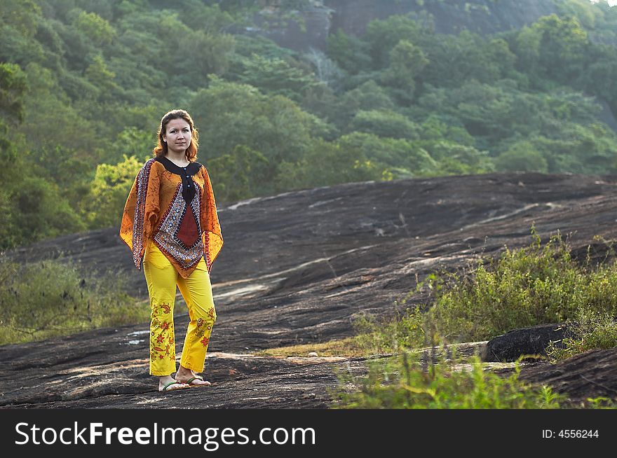 Girl in traditional clothes on the rock. Girl in traditional clothes on the rock