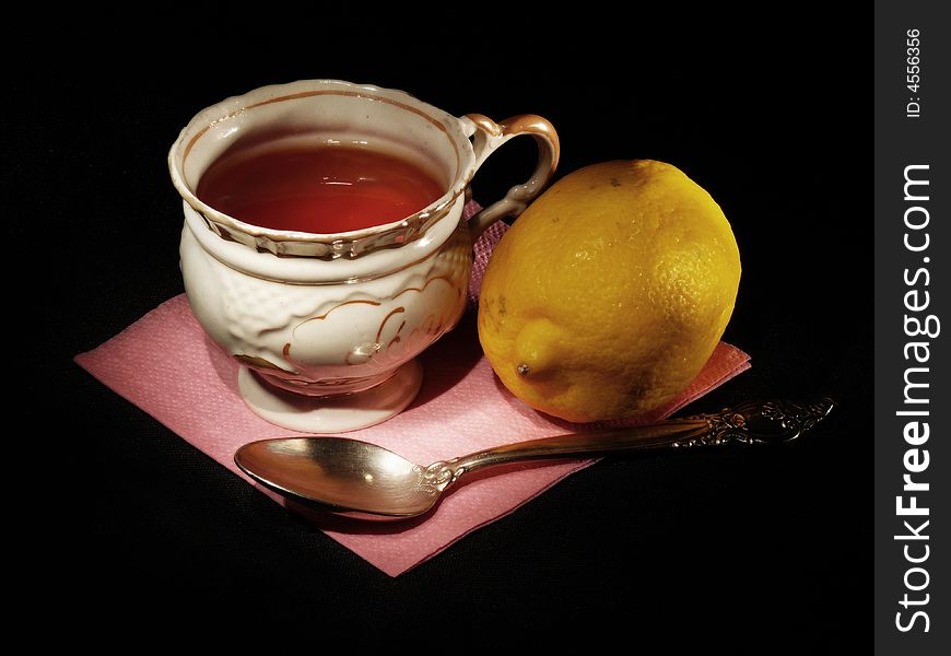 A cup of tea with the lemon and a spoon