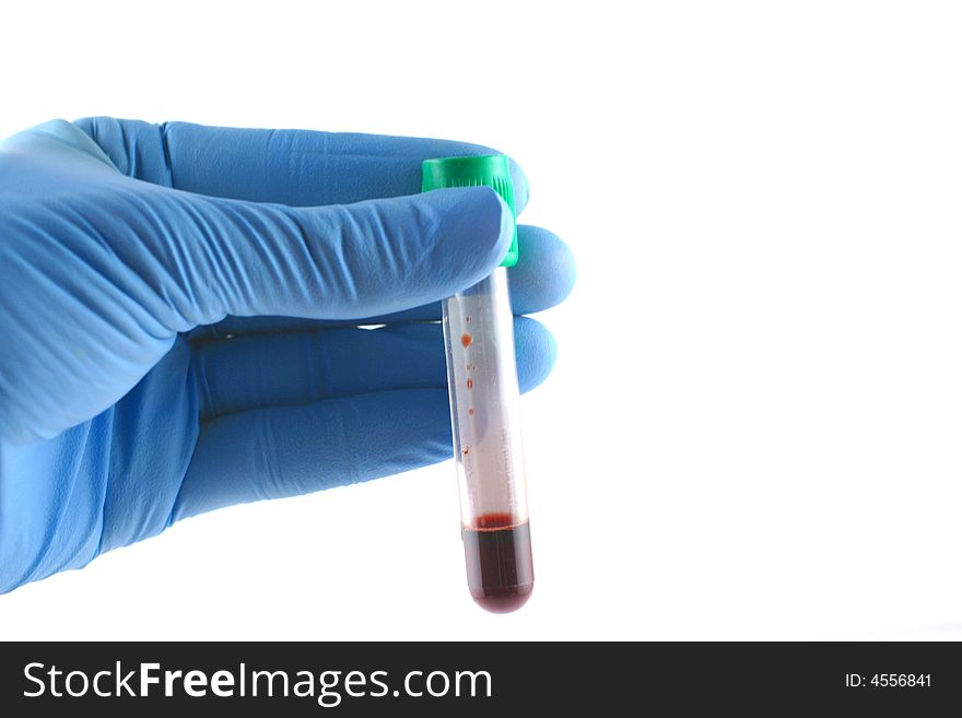 Gloved hand with red liquid filled test tube. Gloved hand with red liquid filled test tube