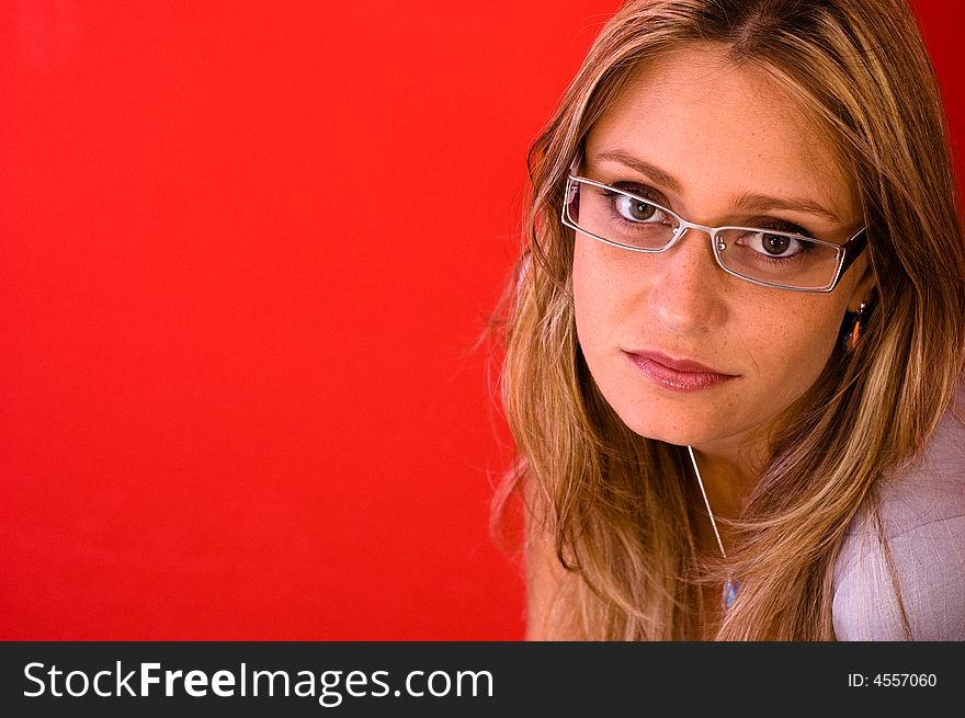 Beautiful woman look to the camera on the red background