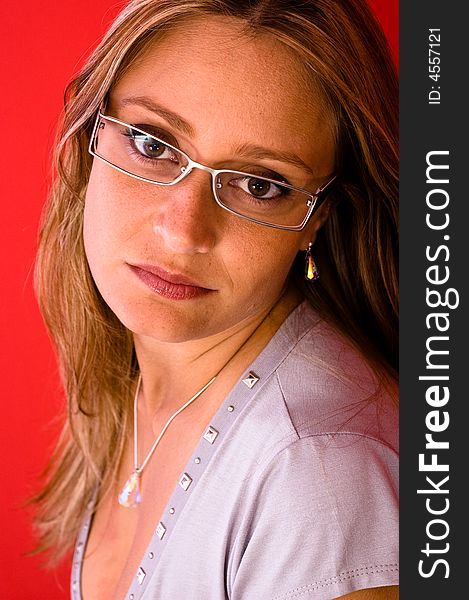 Beautiful woman look to the camera on the red background