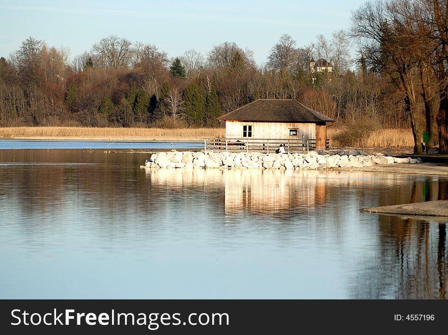 Small nice wood house on the artificial stone island. Small nice wood house on the artificial stone island
