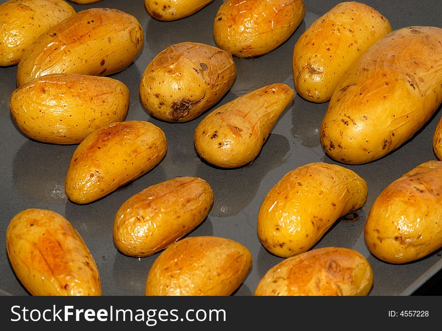 Baked potatoes on the baking tray