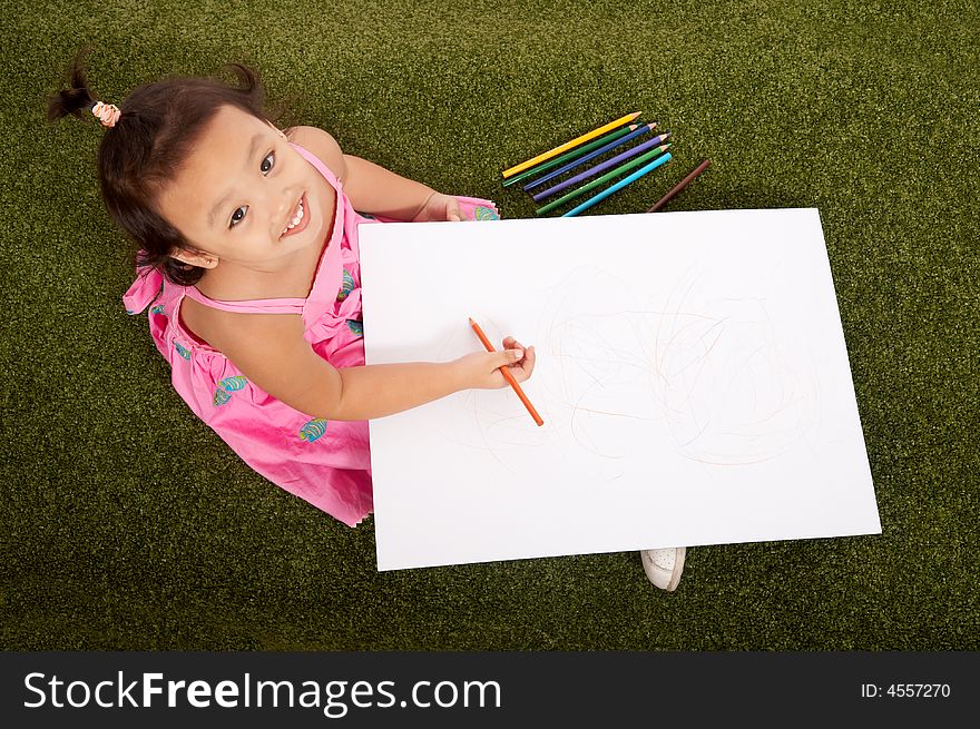 Cheerful young girl holding pen looking up