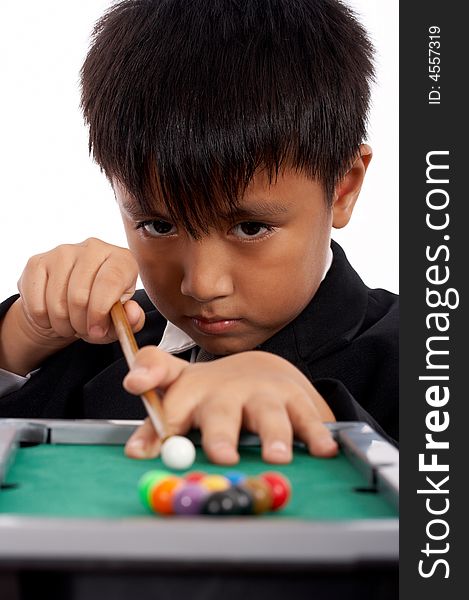 Little boy in black suit playing pool