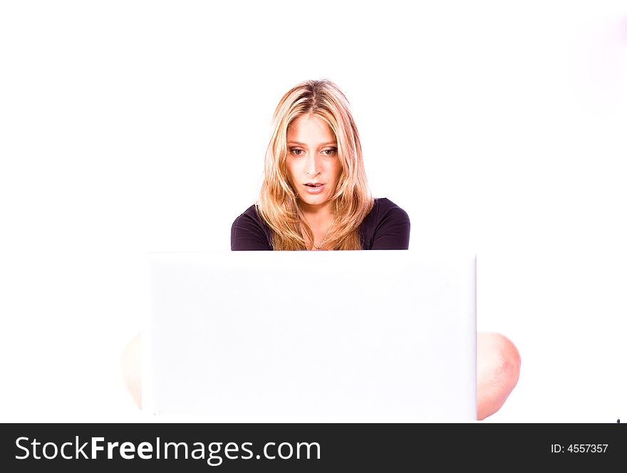 Blond beautiful woman surfing the web on the laptop