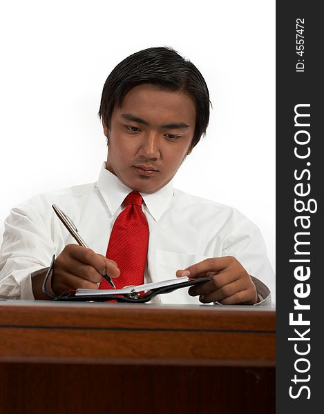 A man sitting behind an office desk. A man sitting behind an office desk