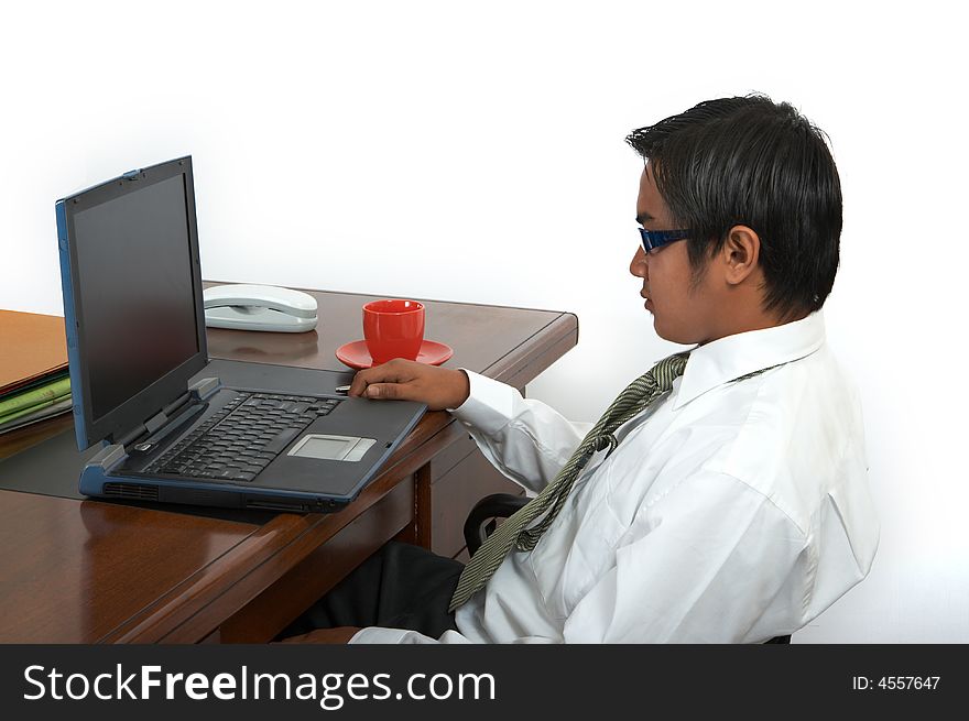 A man working on his laptop over a white background. A man working on his laptop over a white background