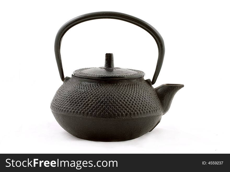 The Chinese iron teapot isolated. The Chinese iron teapot isolated