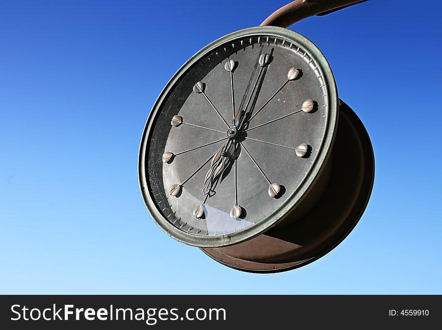 Vintage clock on a nice blue sky