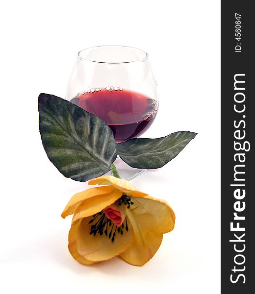 Glass of wine and flower isolated on white background