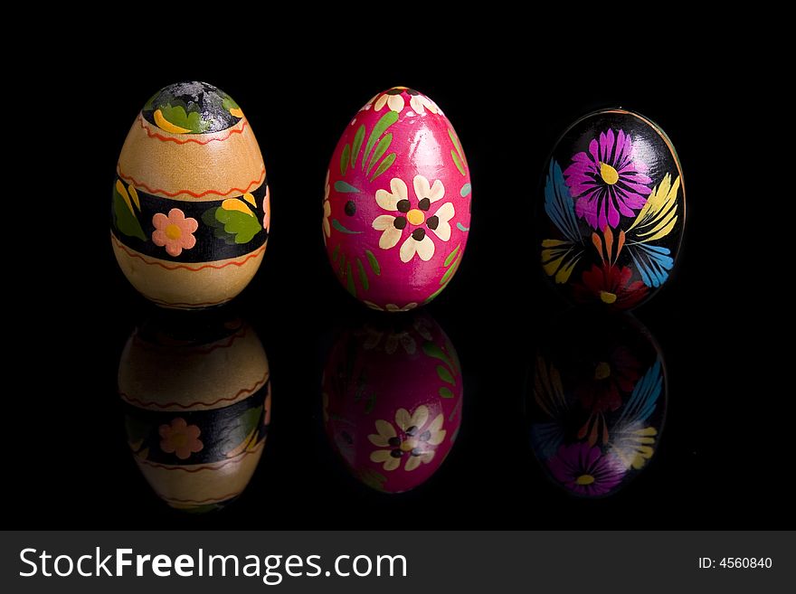Easter eggs on black mirror, hand painted - isolated