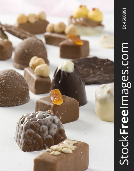 Chocolate pralines on white background. Focus in front. Big depth of field.