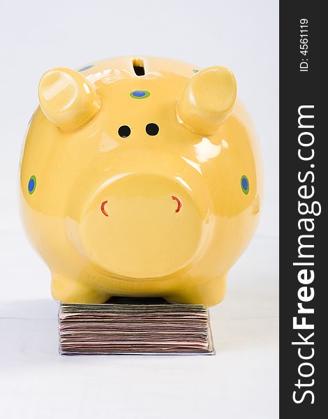 Piggy bank standing on money