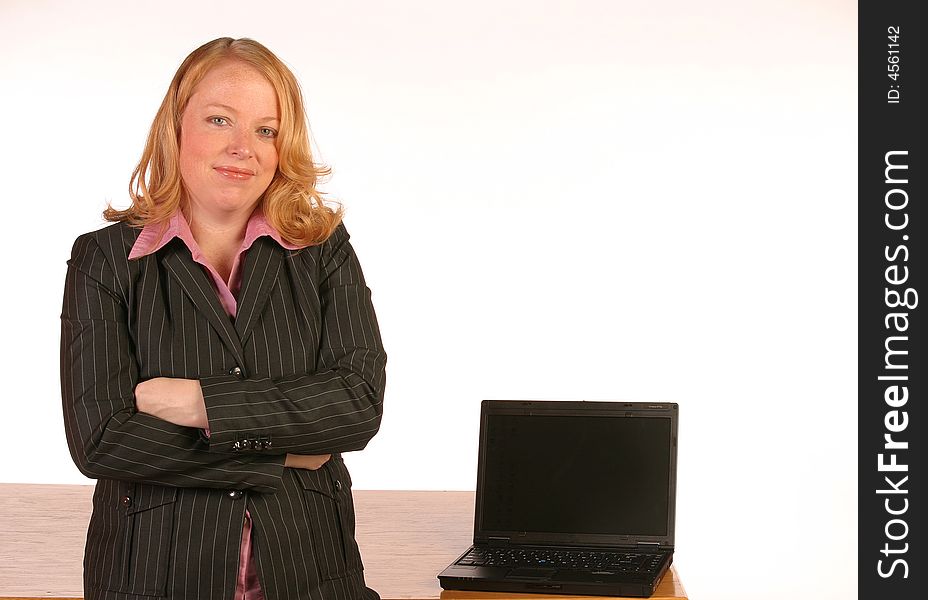 Isolated business woman standing in front of a laptop with a white screen.