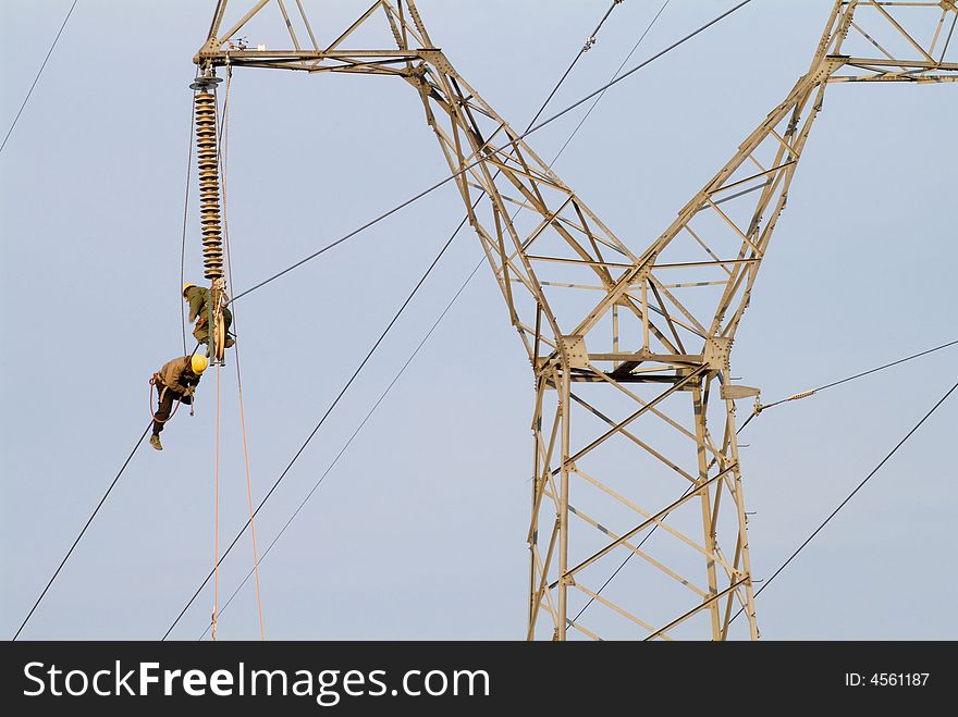 Workers were repairing the lines on the pylon. Workers were repairing the lines on the pylon.